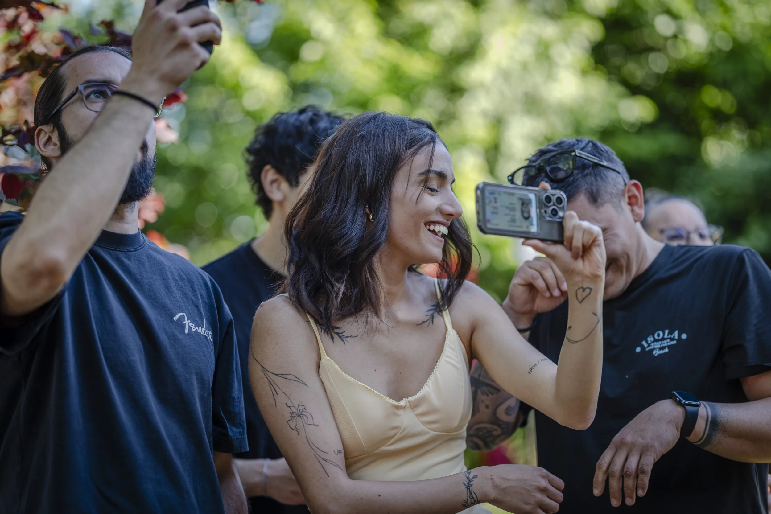 A guest taking a photograph at an outdoor event