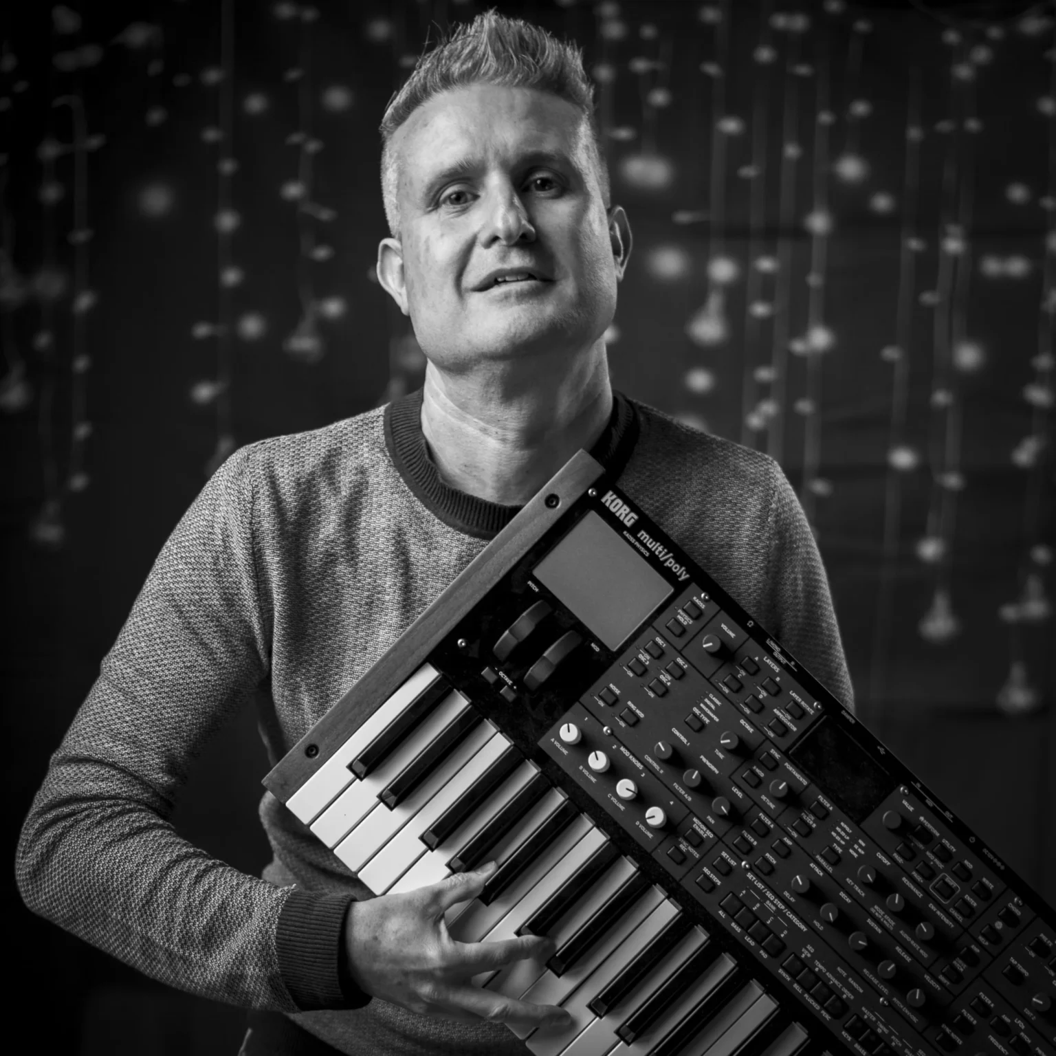 Stefan Ruf holding a synthesizer for Estana Music