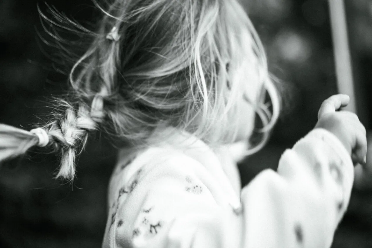 A child moving through soft outdoor light