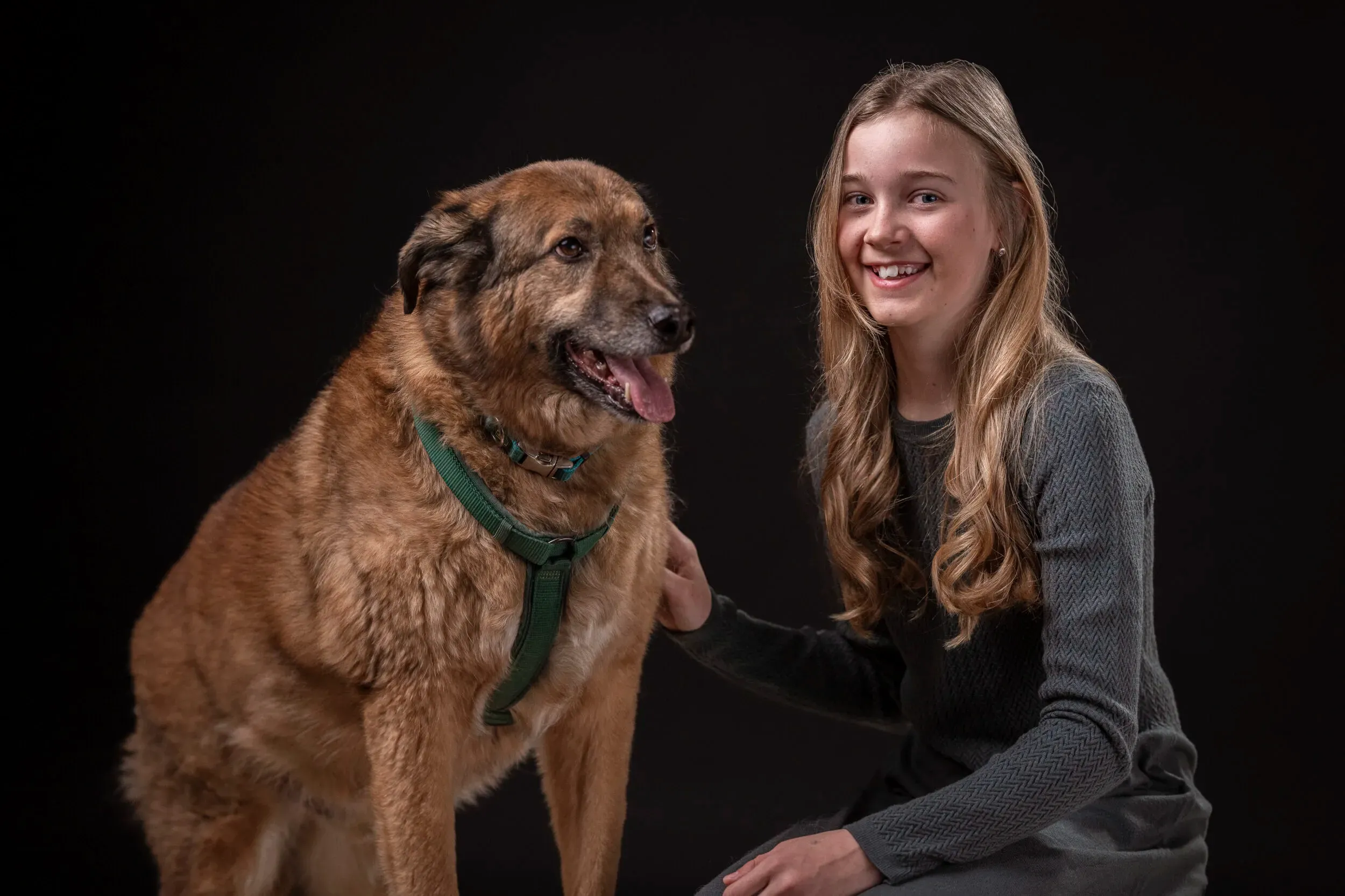 A young woman portrayed with a dog