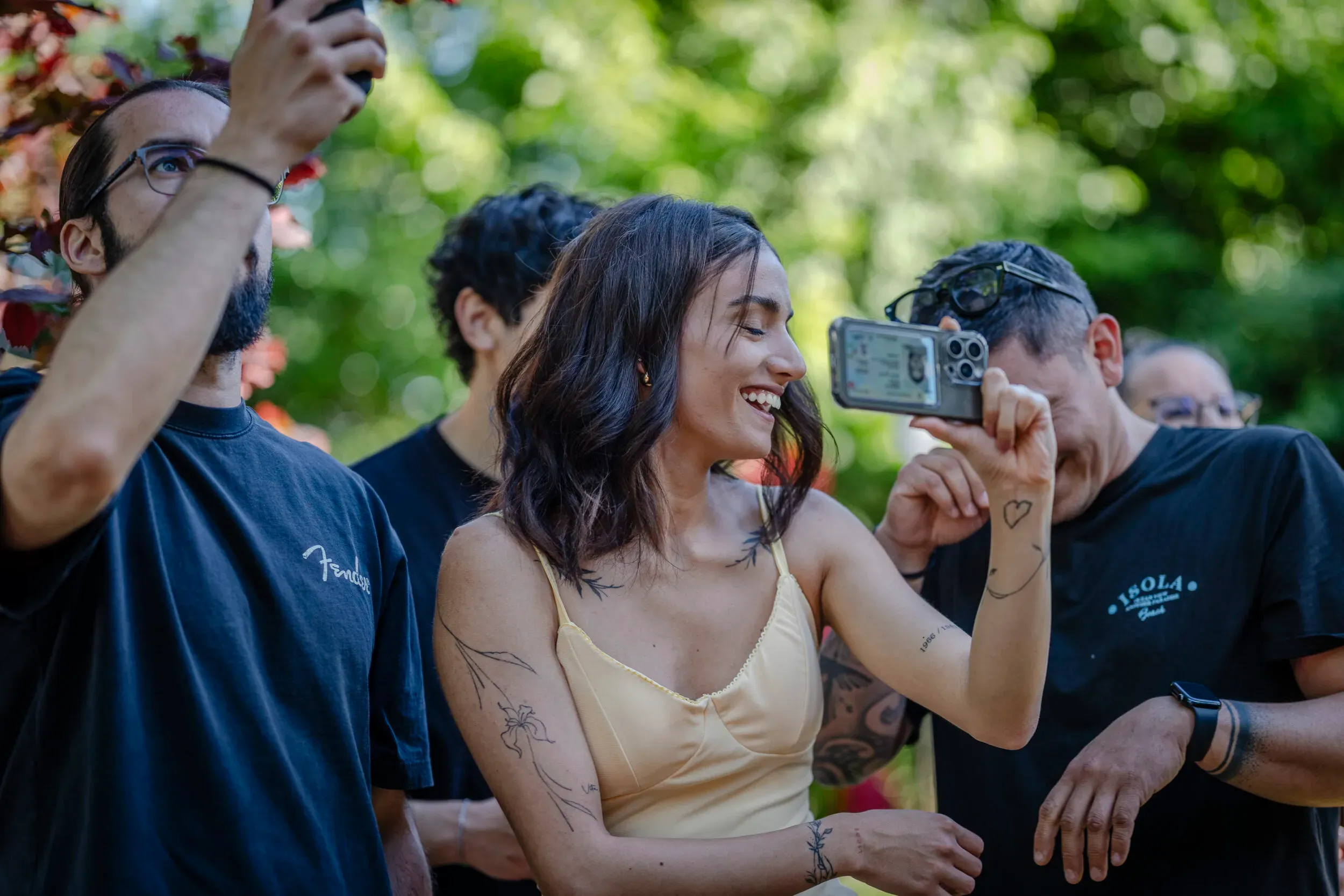 A guest taking a photograph at an outdoor event