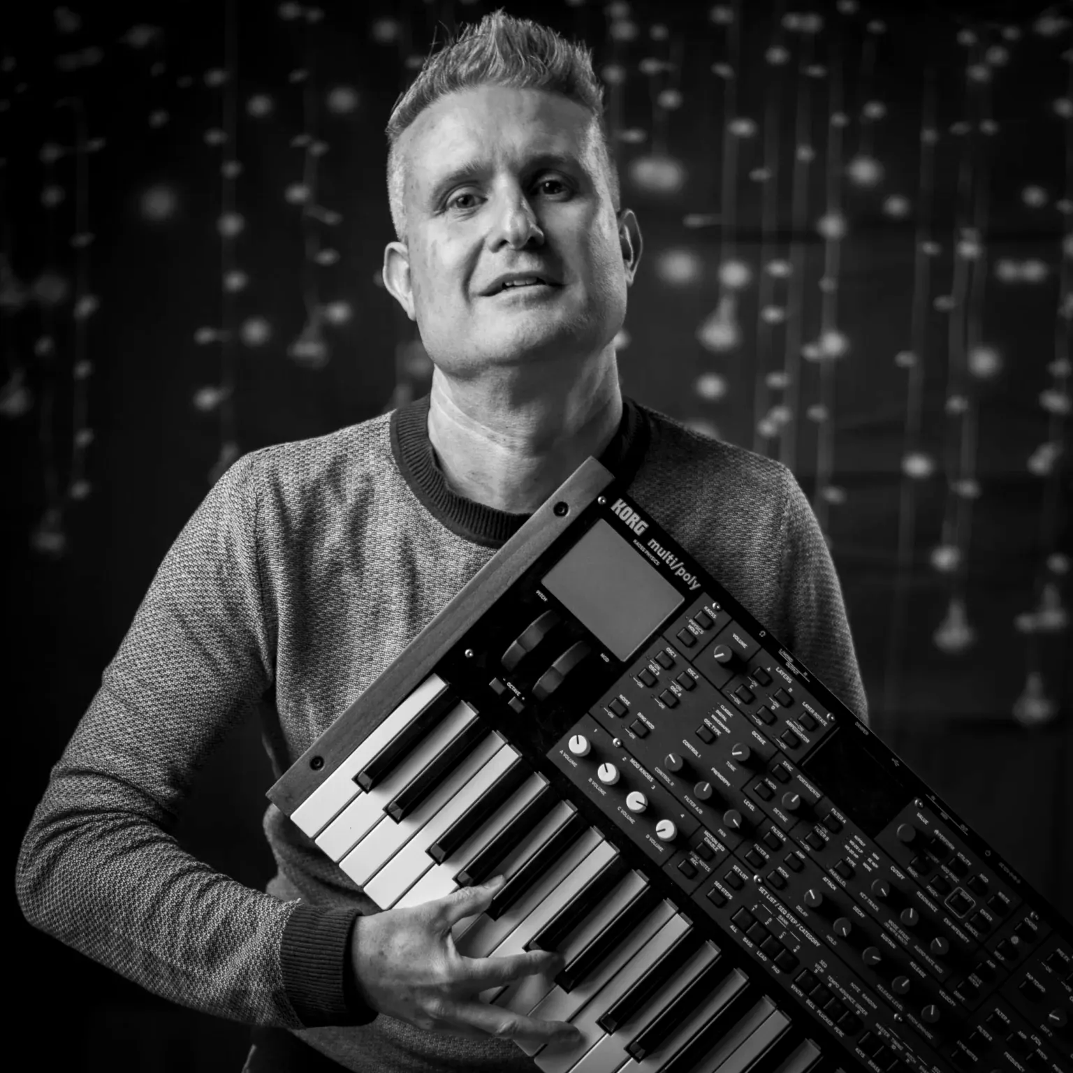 Stefan Ruf holding a synthesizer for Estana Music
